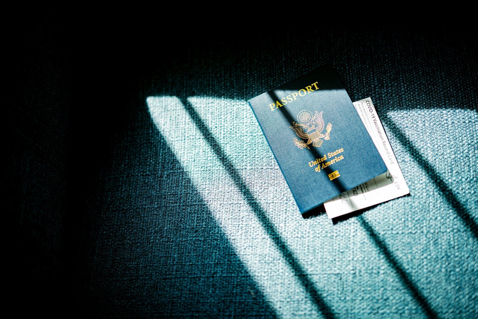 a blue passport sitting on top of a blue couch